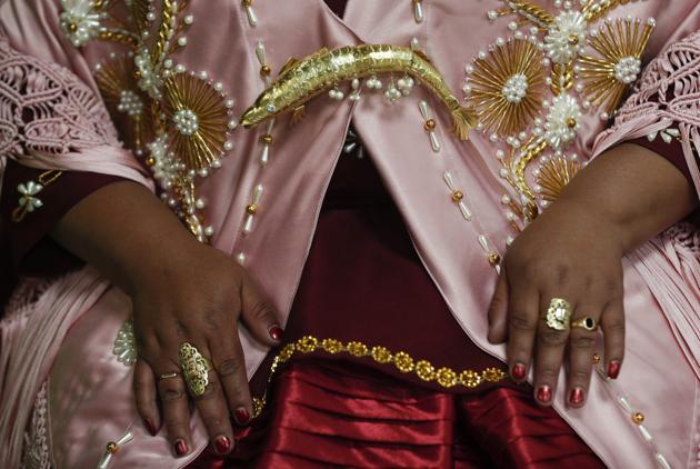 A woman shows off her jewelry before performing at a Chola fashion show in La Paz, Bolivia, Friday, Dec. 4, 2020.  (AP) 
