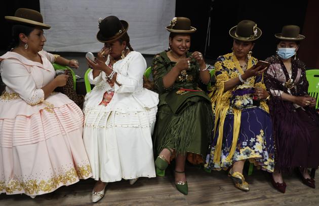 Aymara models prepare to participate before performing at a Chola fashion parade in La Paz, Bolivia, Friday, Dec. 4, 2020.  (AP) 