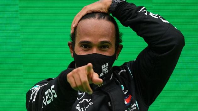 Mercedes' Lewis Hamilton celebrates winning the race on the podium.(Pool via REUTERS) Mercedes' Lewis Hamilton celebrates winning the race on the podium.(Pool via REUTERS)