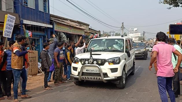 A vehicle of BJP National President JP Nadda's convoy damaged after stone-pelting by alleged TMC activists, at Diamond Harbour, in South 24 Pargana on Thursday. TMC has alleged that BJP staged the attack. (ANI) A vehicle of BJP National President JP Nadda's convoy damaged after stone-pelting by alleged TMC activists, at Diamond Harbour, in South 24 Pargana on Thursday. TMC has alleged that BJP staged the attack. (ANI)