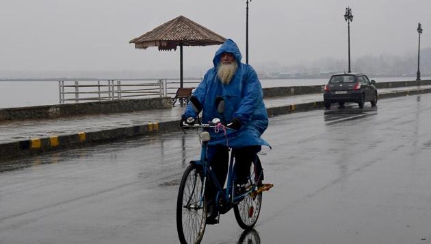 A man rides a bicycle holding an umbrella during rain in Srinagar on December 9. (File photo) A man rides a bicycle holding an umbrella during rain in Srinagar on December 9. (File photo)