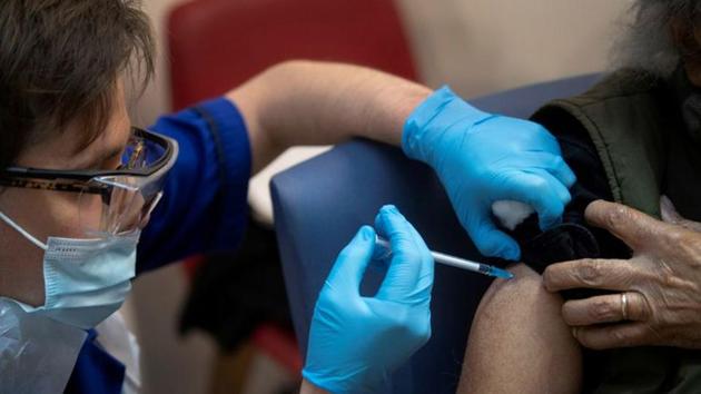 A man receives the first of two Pfizer/BioNTech COVID-19 vaccine jabs, at Guy's Hospital, at the start of the largest ever immunisation programme in the British history, in London, Britain. (REUTERS) A man receives the first of two Pfizer/BioNTech COVID-19 vaccine jabs, at Guy's Hospital, at the start of the largest ever immunisation programme in the British history, in London, Britain. (REUTERS)