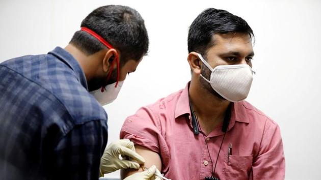 A medic administers COVAXIN, an Indian government-backed experimental COVID-19 vaccine, to a health worker during its trials, at the Gujarat Medical Education & Research Society in Ahmedabad.(REUTERS)