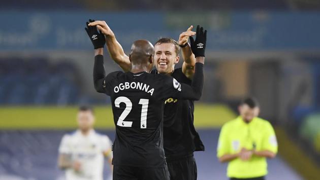 West Ham's Angelo Ogbonna, left, celebrates with his teammate Tomas Soucek at the end of the English Premier League soccer match between Leeds United and West Ham at Elland Road stadium in Leeds, England, Friday, Dec. 11, 2020.(AP)
