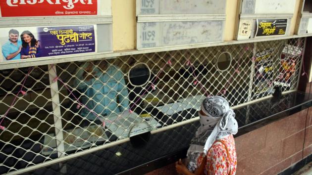 A woman buys tickets for the first show at Yashwantrao Chavan Natyagruha, Kothrud in Pune, India, on Friday, December 11, 2020. (HT PHOTO) A woman buys tickets for the first show at Yashwantrao Chavan Natyagruha, Kothrud in Pune, India, on Friday, December 11, 2020. (HT PHOTO)