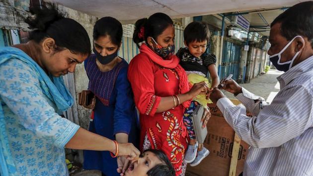A health worker administers polio vaccine to a child as another marks a child on her finger in Kolkata, India.(AP) A health worker administers polio vaccine to a child as another marks a child on her finger in Kolkata, India.(AP)