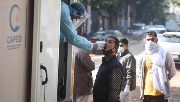 A health worker collects a swab sample to test for Covid-19 infection, at Udyog Nagar in New Delhi, India, on Sunday, December 13, 2020. (Sanchit Khanna/HT photo) A health worker collects a swab sample to test for Covid-19 infection, at Udyog Nagar in New Delhi, India, on Sunday, December 13, 2020. (Sanchit Khanna/HT photo)