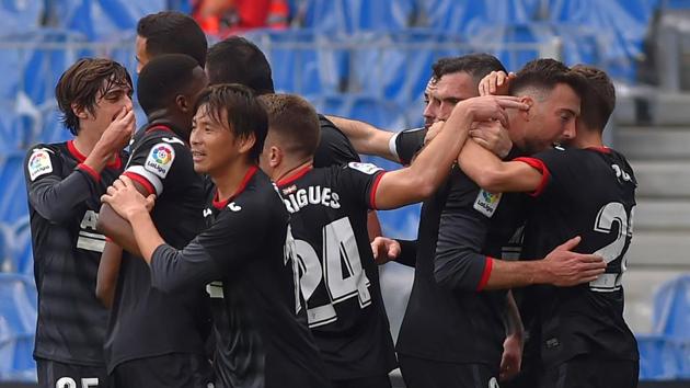 Eibar's Spanish forward Sergi Enrich (2R) celebrates with teammates after scoring a goal during the Spanish league football match between Real Sociedad and SD Eibar at the Anoeta stadium in San Sebastian on December 13, 2020. (Photo by ANDER GILLENEA / AFP)(AFP)