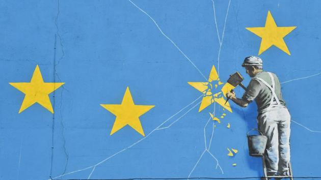 A mural by British artist Banksy depicting a workman chipping away at one of the stars on a European Union (EU) themed flag. (AFP) A mural by British artist Banksy depicting a workman chipping away at one of the stars on a European Union (EU) themed flag. (AFP)