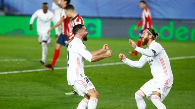 Soccer Football - La Liga Santander - Real Madrid v Atletico Madrid - Estadio Alfredo Di Stefano, Madrid, Spain - December 12, 2020 Real Madrid's Dani Carvajal celebrates with Sergio Ramos after Atletico Madrid's Jan Oblak scored an own goal(REUTERS)