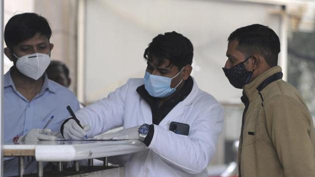 A health worker registers people for coronavirus test, at Sector 30 District Hospital, in Noida on December 12. Two key interventions that have lead to the low death rate are an increase in Covid-19 testing and standardising clinical management of patients, HT reported. (Sunil Ghosh / HT Photo)