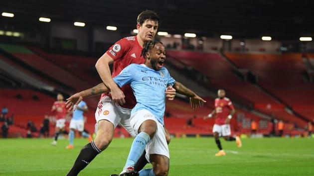 Soccer Football - Premier League - Manchester United v Manchester City - Old Trafford, Manchester, Britain - December 12, 2020 Manchester City's Raheem Sterling in action with Manchester United's Harry Maguire(Pool via REUTERS)