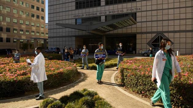 Healthcare workers wearing face masks carry signs in support of resident physicians, interns and fellows at UCLA Health as they protest for improved Covid-19 testing and workplace safety policies, outside UCLA Medical Center in Los Angeles on December 9. The first batch of vaccine shots is expected to be aimed largely at health care workers and residents and staff of long-term care facilities, Reuters reported. (Patrick T Fallon / AFP) Healthcare workers wearing face masks carry signs in support of resident physicians, interns and fellows at UCLA Health as they protest for improved Covid-19 testing and workplace safety policies, outside UCLA Medical Center in Los Angeles on December 9. The first batch of vaccine shots is expected to be aimed largely at health care workers and residents and staff of long-term care facilities, Reuters reported. (Patrick T Fallon / AFP)