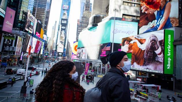 People seen wearing face masks at Times Square in New York on December 10. The United States hit a record 16 million cases of the coronavirus disease (Covid-19) on December 12th afternoon, even as millions of doses of a new vaccine were expected to start rolling out across the nation on December 13, Reuters reported. (Kena Betancur / AFP)