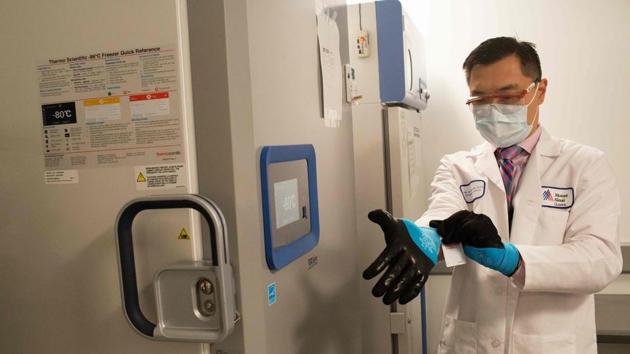 A lab technician puts on protective gloves before opening the vaccine freezer during a dry run at Mount Sinai hospital ahead of an expected Pfizer Covid-19 vaccine shipment, in New York on December 9. The first vaccine was approved late on December 11 by the US Food and Drug Administration and is expected to touch off a mass-inoculation campaign of unparalleled dimension to end the pandemic. (Andrew Lichtenstein / Mount Sinai Health System / AFP) A lab technician puts on protective gloves before opening the vaccine freezer during a dry run at Mount Sinai hospital ahead of an expected Pfizer Covid-19 vaccine shipment, in New York on December 9. The first vaccine was approved late on December 11 by the US Food and Drug Administration and is expected to touch off a mass-inoculation campaign of unparalleled dimension to end the pandemic. (Andrew Lichtenstein / Mount Sinai Health System / AFP)