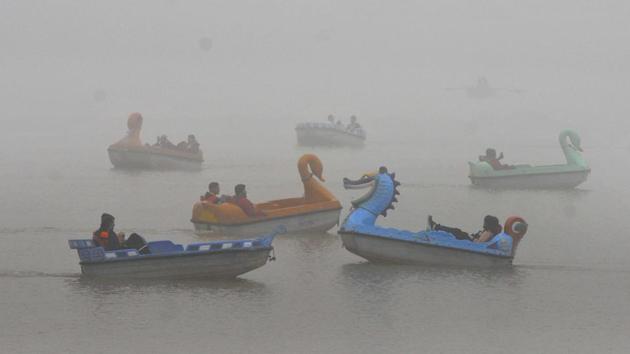 Visitors ride paddle boats on a cold winter morning at Sukhna Lake in Chandigarh on December 13. The India Meteorological Department (IMD) had forecasted, minimum temperatures  likely to fall by 2 to 3 degrees Celsius over northwest India by December 17. The shift in temperatures is both climatological and because of the two passing western disturbances that have brought widespread snowfall to the Western Himalayas. (Keshav Singh / HT Photo) 