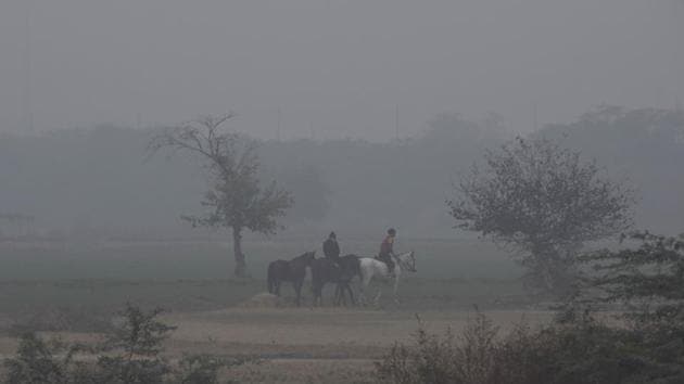 School students ride horses during a practice session on the outskirts of Najafgarh, in New Delhi on December 12. The improvement in air quality on December 14 is associated with northwesterly winds which picked speed and were blowing at 10 to 12 kmph since the previous day, HT reported. (Vipin Kumar / HT Photo) 