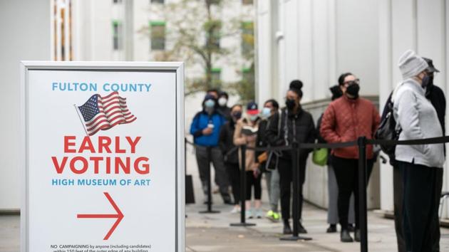 Voters line up for the first day of early voting outside of the High Museum polling station on December 14 in Atlanta, Georgia for a run-off election for two US Senate seats.(AFP) Voters line up for the first day of early voting outside of the High Museum polling station on December 14 in Atlanta, Georgia for a run-off election for two US Senate seats.(AFP)