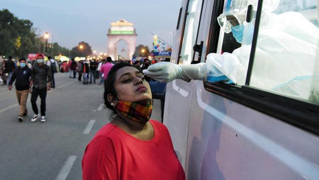 Health workers collect swab samples from a woman for Covid-19 testing at India Gate in New Delhi. (File photo) Health workers collect swab samples from a woman for Covid-19 testing at India Gate in New Delhi. (File photo)