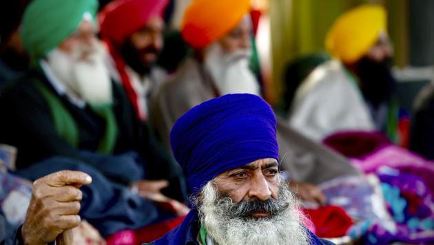 A farmer stands guard as protesting farmer leaders sit on a day long hunger strike at the Delhi- Haryana border, outskirts of New Delhi, Monday, Dec.14, 2020. Tens of thousands of protesting Indian farmers have called for a national strike on Monday, the second in a week, to press for the quashing of three new laws on agricultural reform that they say will drive down crop prices and devastate their earnings.(AP) A farmer stands guard as protesting farmer leaders sit on a day long hunger strike at the Delhi- Haryana border, outskirts of New Delhi, Monday, Dec.14, 2020. Tens of thousands of protesting Indian farmers have called for a national strike on Monday, the second in a week, to press for the quashing of three new laws on agricultural reform that they say will drive down crop prices and devastate their earnings.(AP)