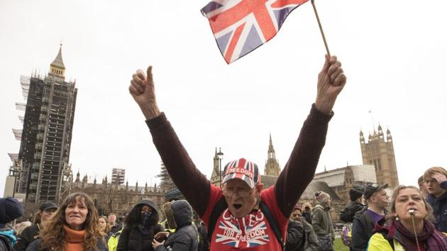 An anti-mask demonstration gathers outside the Houses of Parliament in London on December 14.(Bloomberg)