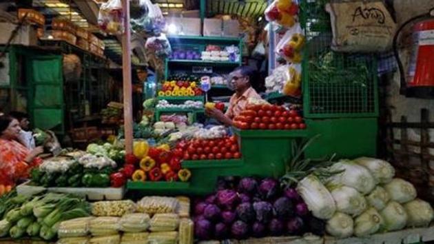 A vendor sells vegetables at a retail market in Kolkata.(Reuters)