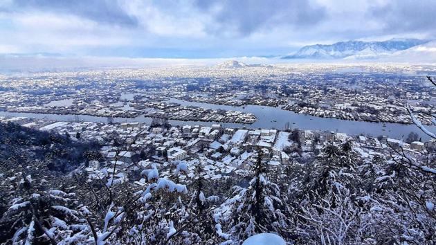 A view of snow-covered rooftops in Srinagar on December 12. A cold wave gripped Delhi on December 15 as icy winds blowing from the snow-covered western Himalayas brought the minimum temperature down to 4.1 degrees Celsius, the season’s lowest so far, PTI reported. The reading at Safdarjung Observatory, which provides representative data for the city, was five notches below normal. (Waseem Andrabi / HT Photo)