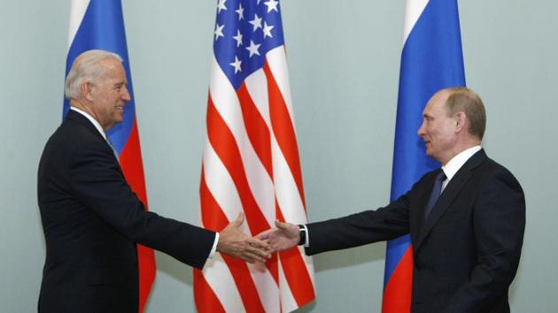 FILE - In this March 10, 2011, file photo, Vice President of the United States Joe Biden, left, shakes hands with Russian Prime Minister Vladimir Putin in Moscow, Russia. (AP) FILE - In this March 10, 2011, file photo, Vice President of the United States Joe Biden, left, shakes hands with Russian Prime Minister Vladimir Putin in Moscow, Russia. (AP)