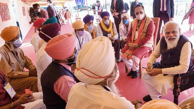 Prime Minister Narendra Modi Modi meets various groups of people, in Kutch, Tuesday, Dec. 15, 2020. Gujarat Chief Minister Vijay Rupani is also seen.(PTI)