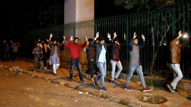 Students with their hands raised above their heads leave the Jamia Milia University. Biswal said that the police’s entry into the Jamia campus was necessary as many protesters ran into the varsity premises while being chased by the police. “They needed to be brought out and the campus secured,” he said, denying that the police targeted students inside. (Adnan Abidi / REUTERS)