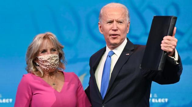 US President-elect Joe Biden arrives with his wife Jill Biden to deliver remarks on the electoral college certification at the Queen Theatre in Wilmington, Delaware on December 14, 2020.(AFP)