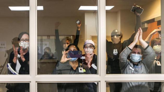 Mercy Hospital South staff applaud and cheer after watching a doctor receive the Pfizer-BioNTech vaccine in the St. Louis Region at the hospital in St. Louis County on December 14. The vaccine was cleared for emergency use last week before a final study in nearly 44,000 people was complete. (Cheyenne Boone / St. Louis Post-Dispatch via AP) Mercy Hospital South staff applaud and cheer after watching a doctor receive the Pfizer-BioNTech vaccine in the St. Louis Region at the hospital in St. Louis County on December 14. The vaccine was cleared for emergency use last week before a final study in nearly 44,000 people was complete. (Cheyenne Boone / St. Louis Post-Dispatch via AP)