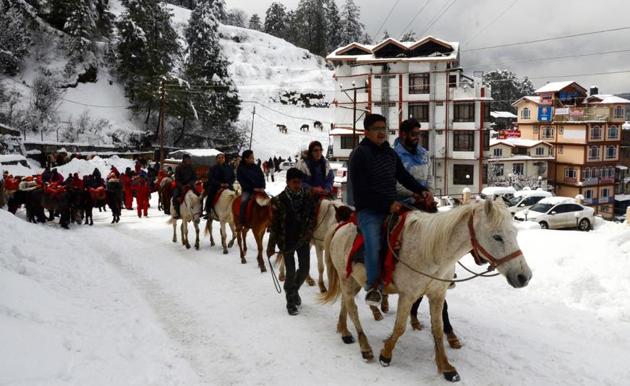 Tourists enjoying a pony ride at Kufri near Shimla on Wednesday.(HT Photo)