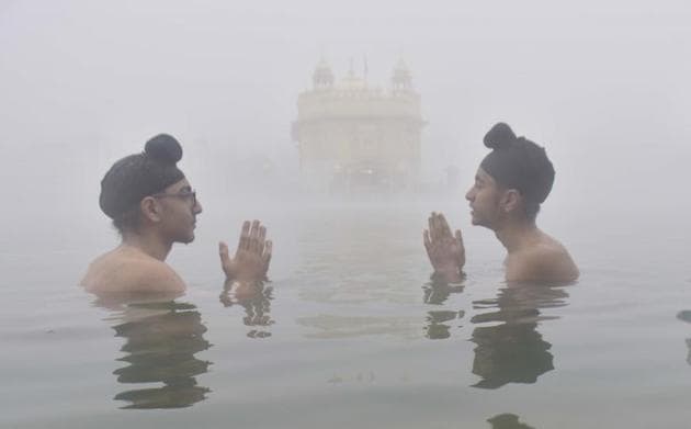 Young devotees taking a dip in the(Sameer Sehgal/HT)