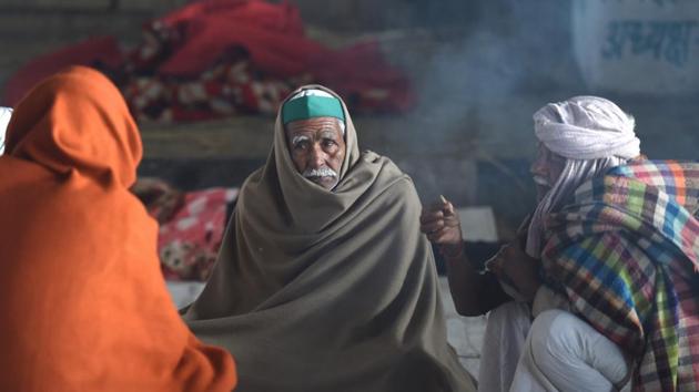 Farmers cover themselves with blankets on a cold morning during their sit-in protest against the Centre's farm reform laws, at Ghazipur border in New Delhi. (PTI) Farmers cover themselves with blankets on a cold morning during their sit-in protest against the Centre's farm reform laws, at Ghazipur border in New Delhi. (PTI)