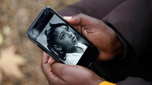 In this photo taken on November 30, Rosamund Adoo-Kissi-Debrah holds her mobile phone displaying a photograph of her daughter Ella Adoo-Kissi-Debrah who died in February 2013 from a severe asthma attack ahead of the opening of a coroner's inquest into the girl's death in London. (AFP file) In this photo taken on November 30, Rosamund Adoo-Kissi-Debrah holds her mobile phone displaying a photograph of her daughter Ella Adoo-Kissi-Debrah who died in February 2013 from a severe asthma attack ahead of the opening of a coroner's inquest into the girl's death in London. (AFP file)