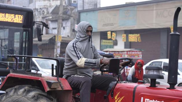 A man rides a tractor while being tucked inside his sweater on a cold winter morning at Old Delhi road in Gurugram on December 16. Delhi recorded a minimum temperature of 5.8 degrees Celsius (until 9am) on December 16, around 2 degrees higher than the previous day’s minimum of 4.1 degrees Celsius. (Parveen Kumar / HT Photo)