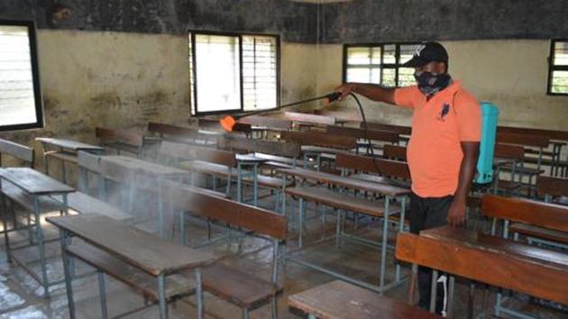 A municipal worker sanitises a classroom of a school ahead of its reopening from November 23 in rural Pune, after a gap of nearly eight months in Karad, Maharashtra, India, on Friday, November 20, 2020. (HT FILE PHOTO) A municipal worker sanitises a classroom of a school ahead of its reopening from November 23 in rural Pune, after a gap of nearly eight months in Karad, Maharashtra, India, on Friday, November 20, 2020. (HT FILE PHOTO)
