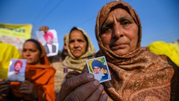 Relatives of farmers who are believed to have died by suicide over debt issues, seen holding photographs of the deceased during the ongoing protest against new farm laws, at Tikri Border in New Delhi.(Amal KS/HT PHOTO) Relatives of farmers who are believed to have died by suicide over debt issues, seen holding photographs of the deceased during the ongoing protest against new farm laws, at Tikri Border in New Delhi.(Amal KS/HT PHOTO)