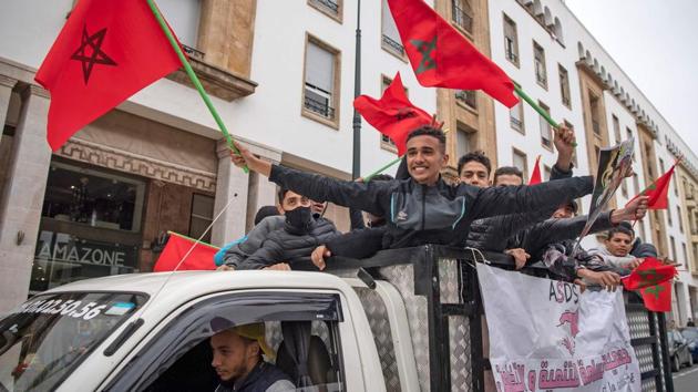 Moroccans celebrate in front of the parliament building in Rabat after the US adopted a new official map of Morocco that includes the disputed territory of Western Sahara.(AFP PHOTO.) Moroccans celebrate in front of the parliament building in Rabat after the US adopted a new official map of Morocco that includes the disputed territory of Western Sahara.(AFP PHOTO.)