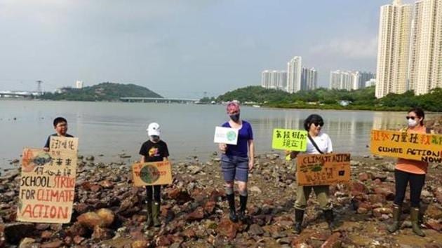 Lance Lau, 11, Elise Hon, 11, Rose Netherton, 36, and other climate activists hold placards as they pose for pictures during a climate strike and a beach clean-up at San Tau Beach on Lantau island in Hong Kong, China. (Reuters file photo) Lance Lau, 11, Elise Hon, 11, Rose Netherton, 36, and other climate activists hold placards as they pose for pictures during a climate strike and a beach clean-up at San Tau Beach on Lantau island in Hong Kong, China. (Reuters file photo)