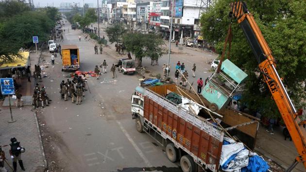 Municipal workers and police clear the Shaheen Bagh protest site after 101 days on sit-in on March 24. The Covid-19 pandemic achieved what the courts or police could not, and the protest site was cleared the day before the national lockdown was imposed to contain the spread of the coronavirus disease. (Salman Ali / HT Archive)