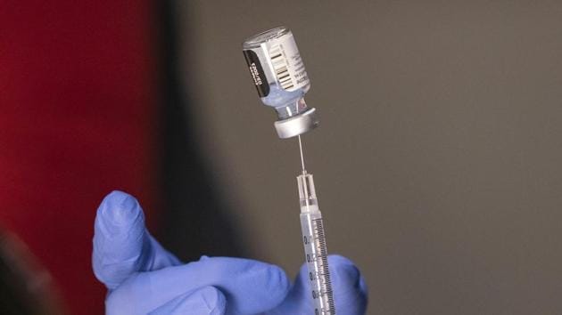 Pharmacist Ron Simono fills a syringe with a dose of the Pfizer-BioNtech Covid-19 vaccine during a vaccine clinic on Wednesday.(AP Photo)