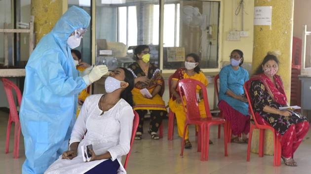 A medical staff collects swab sample of a textile department official at Nishtha Bhavan, Churchgate in Mumbai on Thursday.(Anshuman Poyrekar/HT Photo)