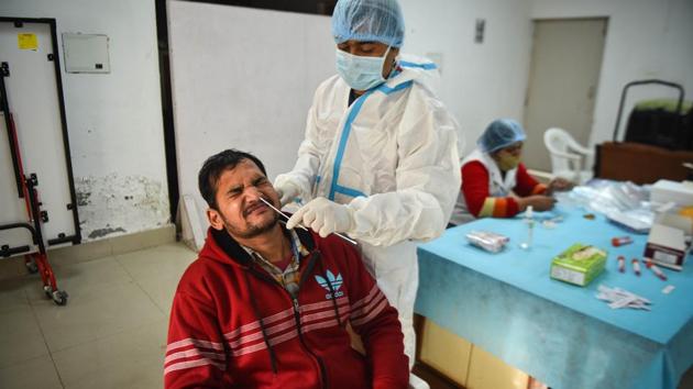 A health worker collects a swab sample to test for coronavirus infection, at UGC, ITO in New Delhi on Thursday. (Sanchit Khanna/HT Photo) A health worker collects a swab sample to test for coronavirus infection, at UGC, ITO in New Delhi on Thursday. (Sanchit Khanna/HT Photo)