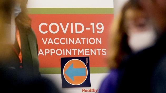 A Covid-19 vacation appointments sign points the way at Edward Hospital in Naperville, Ill., Thursday.(AP Photo)