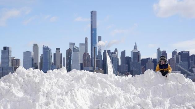 A child plays on a mound of snow in New York City on December 17. A Nor’easter storm buried parts of upstate New York and Northeastern United States in snow, breaking records in cities and towns across the region, and left plough drivers struggling to clear the roads as snow piled up at more than 4 inches per hour, AP reported. (Seth Wenig / AP)