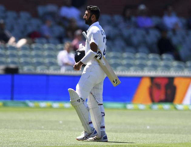 India's Cheteshwar Pujara walks off after he lost his wicket to Australia's Pat Cummins on the third day of their cricket test match at the Adelaide Oval in Adelaide, Australia, Saturday, Dec. 19, 2020. (AP Photo/David Mairuz) (AP)