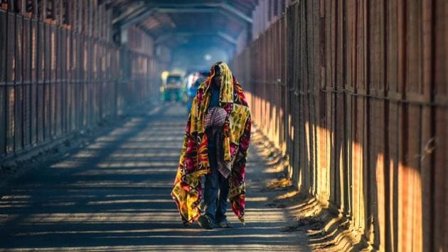 A man wrapped in a blanket walks on the old Yamuna bridge amid cold weather in New Delhi on Friday. (Amal KS/HT Photo) A man wrapped in a blanket walks on the old Yamuna bridge amid cold weather in New Delhi on Friday. (Amal KS/HT Photo)