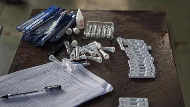 Covid-19 test samples taken from travellers are seen kept on a table at a railway platform in Mumbai on December 19. India’s case fatality rate (CFR) — the proportion of infected people who have died from the disease — is 1.45%, better than the global average of 2.22. This has come along with improvement in test positivity rate, which is at its lowest ever. In the past week, 2.6% of all samples tested have come back positive for Covid-19 — the lowest since April. (Punit Paranjpe / AFP) 